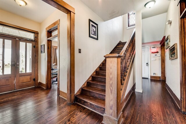 entryway featuring stairs, french doors, baseboards, and wood finished floors