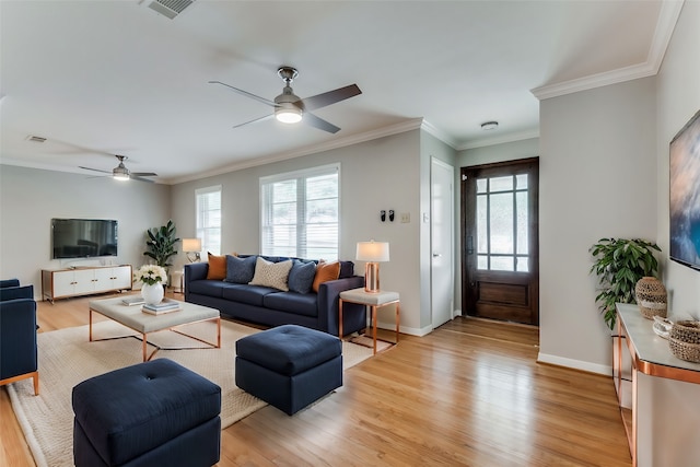 living room featuring light wood-type flooring, ceiling fan, and crown molding