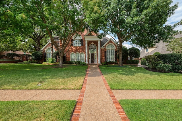 view of front of property with brick siding and a front yard