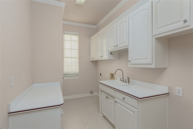 kitchen featuring light tile patterned floors, sink, ornamental molding, and white cabinets