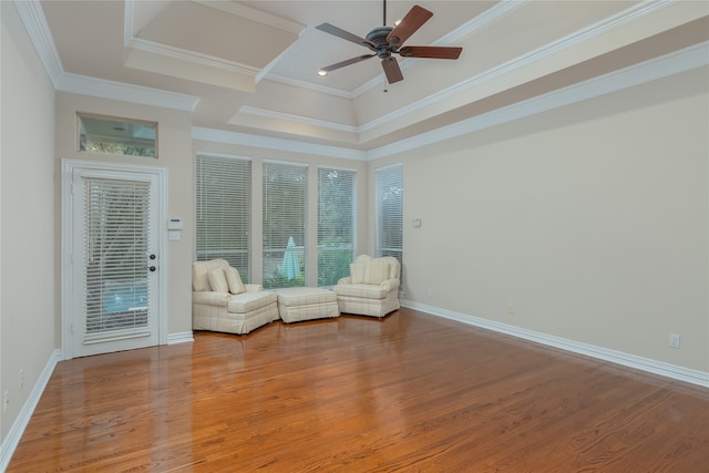 unfurnished room featuring ceiling fan, a raised ceiling, crown molding, and light hardwood / wood-style flooring