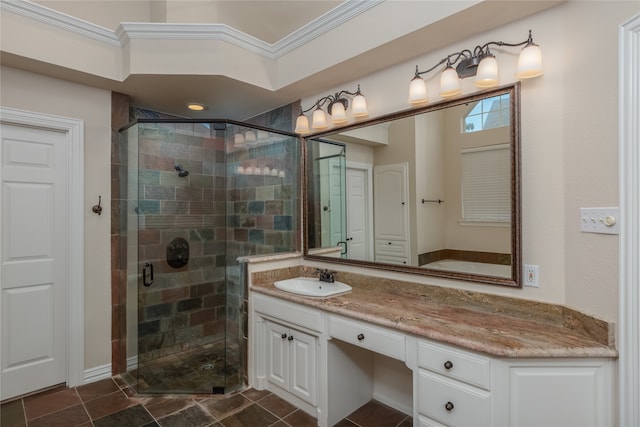 bathroom featuring tile patterned flooring, ornamental molding, walk in shower, and vanity