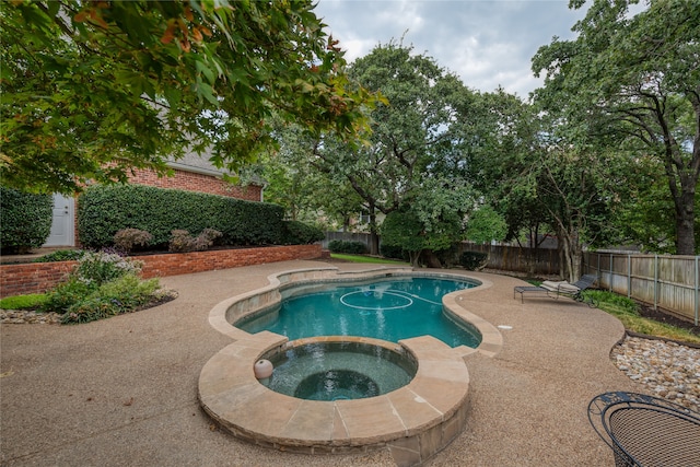 view of pool featuring an in ground hot tub and a patio