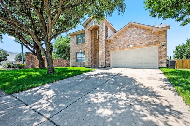 front of property with central air condition unit, a garage, and a front lawn