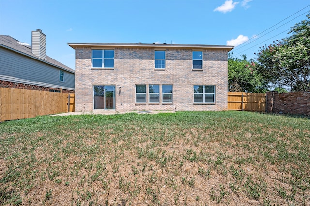 rear view of property featuring a yard