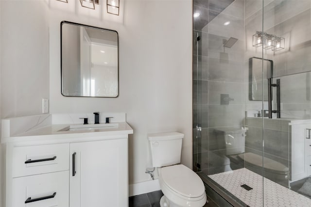 bathroom with toilet, an enclosed shower, and vanity