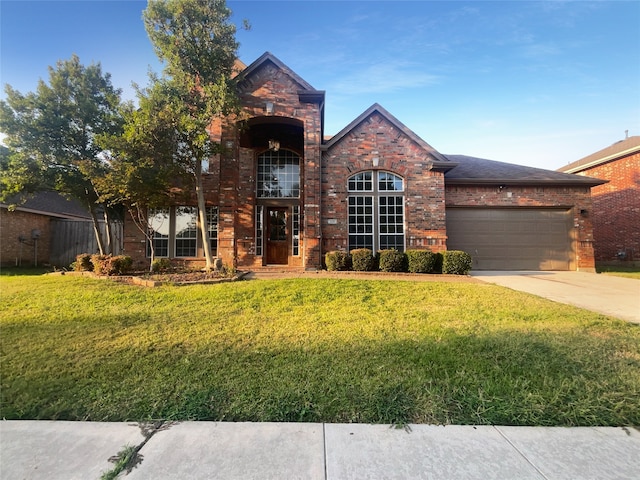 view of front facade with a front yard and a garage