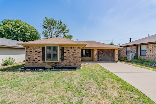 ranch-style home featuring central air condition unit and a front yard