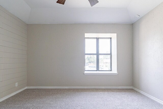 carpeted spare room with ceiling fan and lofted ceiling