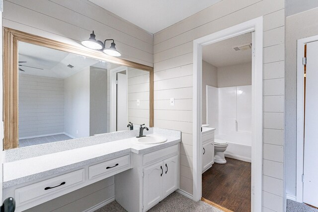 bathroom with hardwood / wood-style flooring, toilet, and vanity