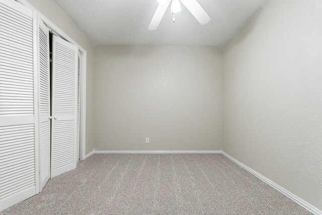 unfurnished bedroom with carpet flooring, ceiling fan, and a closet