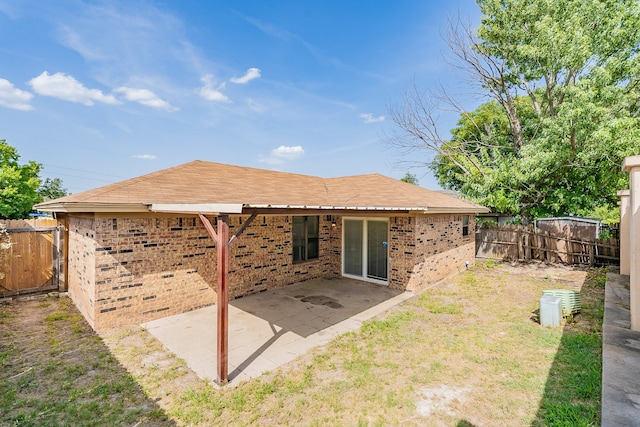 back of house with a patio area and a yard