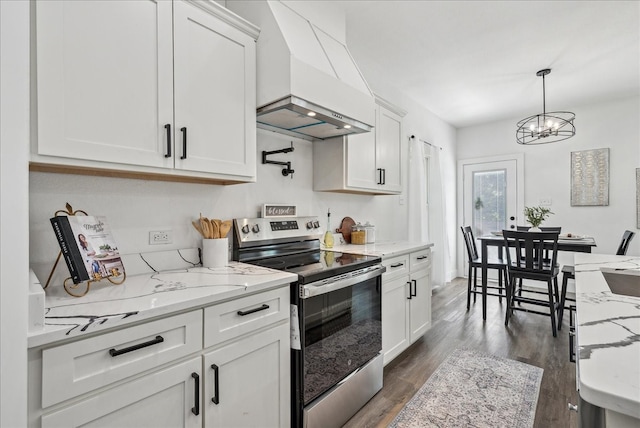 kitchen with stainless steel electric range, light stone counters, premium range hood, dark wood-type flooring, and white cabinets