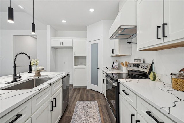 kitchen featuring dark hardwood / wood-style flooring, pendant lighting, premium range hood, appliances with stainless steel finishes, and sink