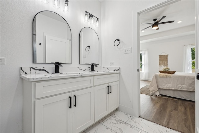 bathroom with ceiling fan, wood-type flooring, and vanity