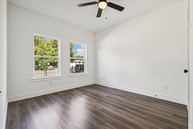 empty room with ceiling fan and dark hardwood / wood-style flooring