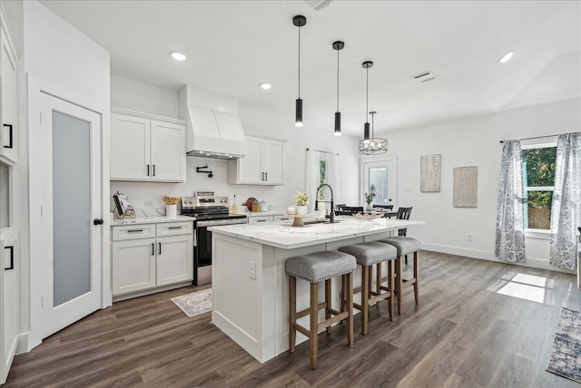 kitchen featuring a kitchen island with sink, white cabinetry, premium range hood, electric range, and dark wood-type flooring