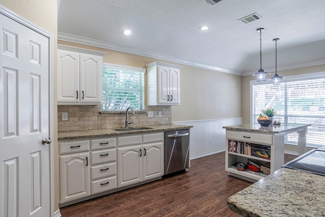 kitchen featuring a healthy amount of sunlight, stainless steel dishwasher, sink, and vaulted ceiling