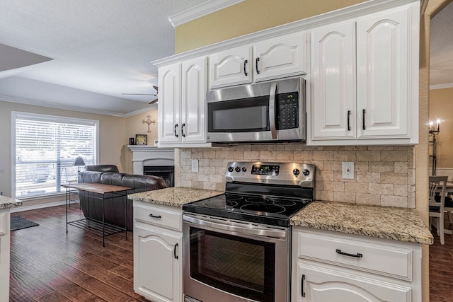 kitchen featuring crown molding, stainless steel appliances, dark hardwood / wood-style floors, and white cabinetry