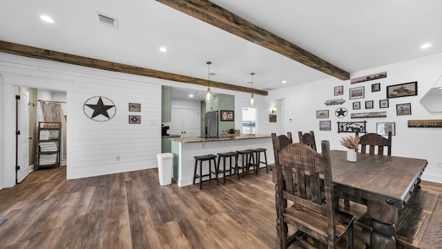 dining space featuring beam ceiling and dark hardwood / wood-style flooring