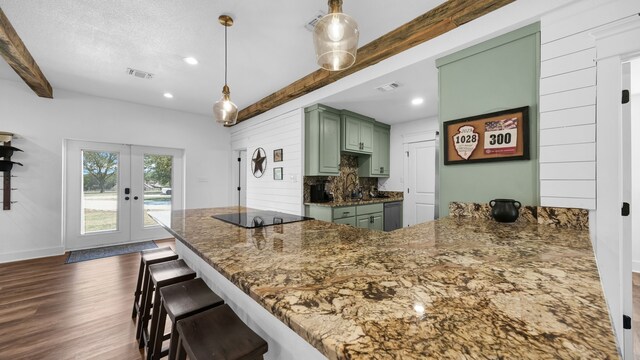 kitchen with hanging light fixtures, dark hardwood / wood-style floors, beam ceiling, and green cabinets