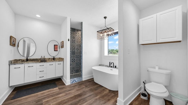 full bathroom featuring vanity, separate shower and tub, toilet, and hardwood / wood-style flooring