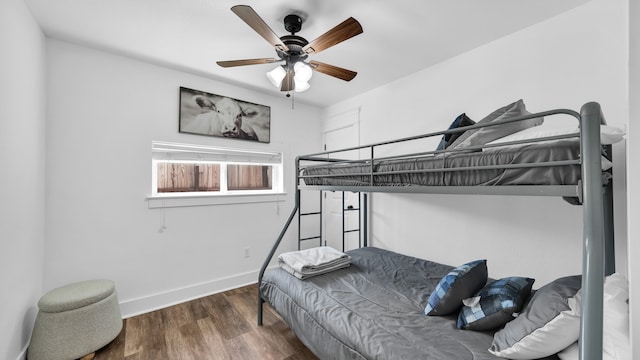 bedroom with ceiling fan and dark hardwood / wood-style floors