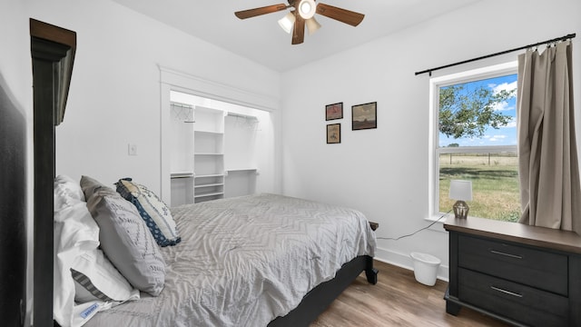 bedroom with ceiling fan, a closet, and light wood-type flooring