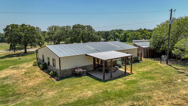 back of house with a yard and a patio area