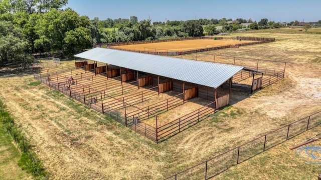 view of horse barn with an outdoor structure and a rural view