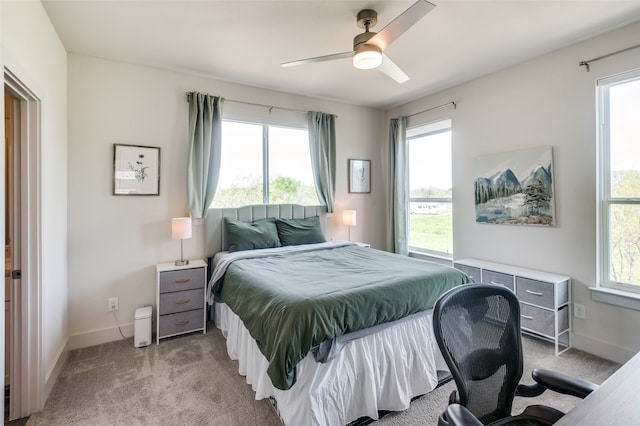 bedroom featuring light colored carpet and ceiling fan