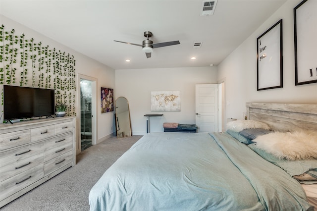 bedroom featuring light carpet, connected bathroom, and ceiling fan