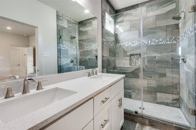 bathroom with an enclosed shower and vanity