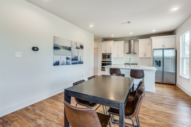 dining area with light hardwood / wood-style floors