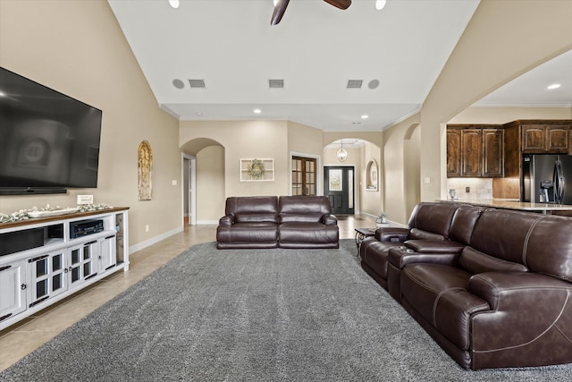 living room featuring ceiling fan, ornamental molding, and light tile patterned flooring