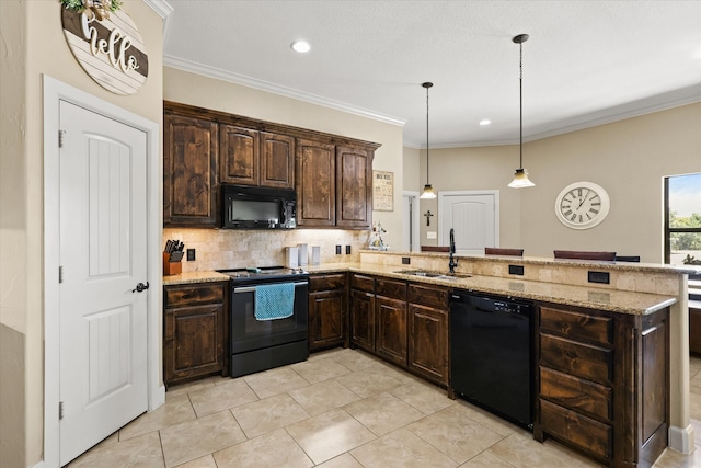 kitchen with black appliances, pendant lighting, sink, decorative backsplash, and dark brown cabinetry