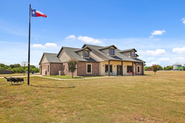 view of front of home with cooling unit, a garage, and a front lawn