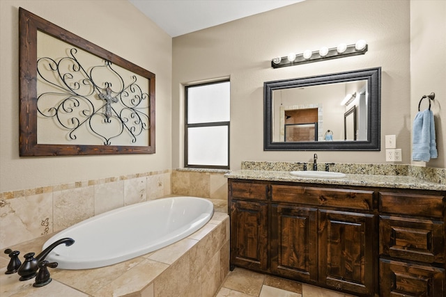 bathroom with vanity and a relaxing tiled tub