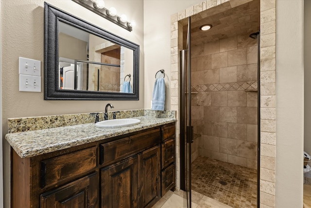 bathroom with vanity, tile patterned flooring, and a shower with door