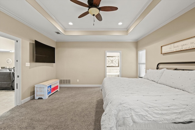 bedroom with ceiling fan, a raised ceiling, light carpet, and ornamental molding