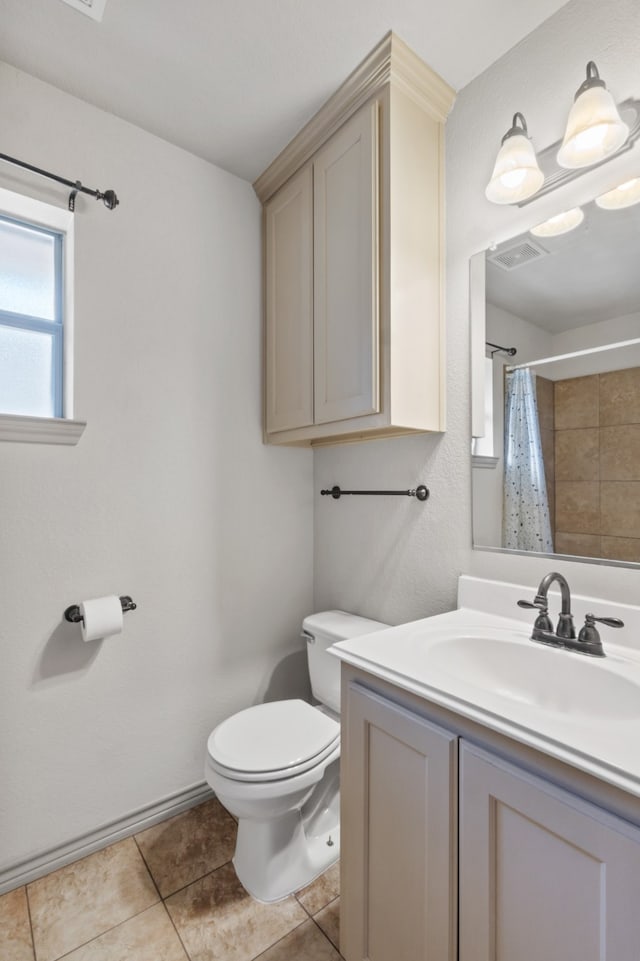 bathroom featuring vanity, toilet, curtained shower, and tile patterned flooring