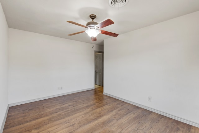 empty room with ceiling fan and hardwood / wood-style flooring