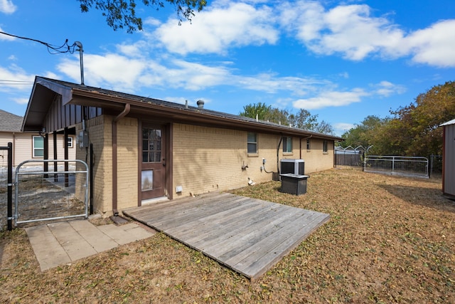 back of house with a yard and central AC