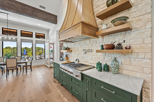 9 Meadowlake Dr, Heath, TX 75032 - kitchen featuring stainless steel gas stovetop, green cabinetry, open shelves, visible vents, and custom range hood