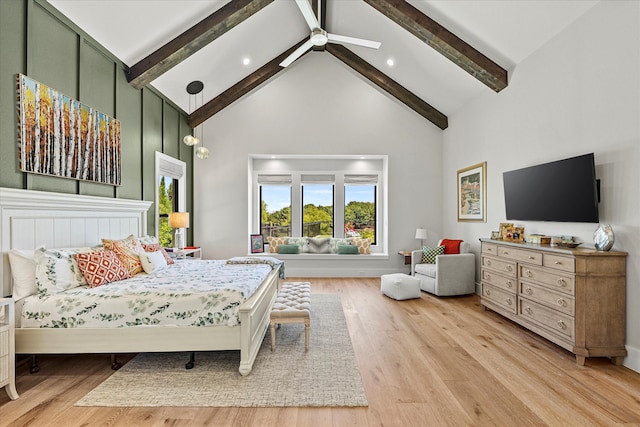 bedroom with light wood-type flooring, high vaulted ceiling, and beam ceiling