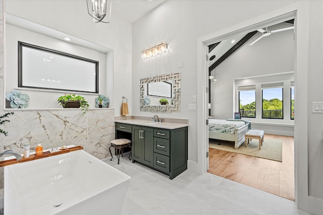 bathroom with hardwood / wood-style floors, a bathing tub, beamed ceiling, high vaulted ceiling, and vanity