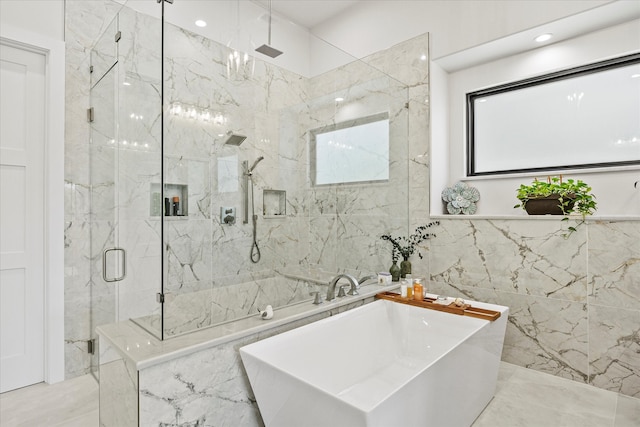 bathroom with tile walls, independent shower and bath, and tile patterned floors