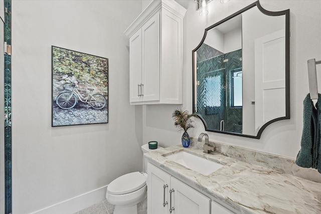 bathroom with vanity, toilet, tile patterned floors, and walk in shower