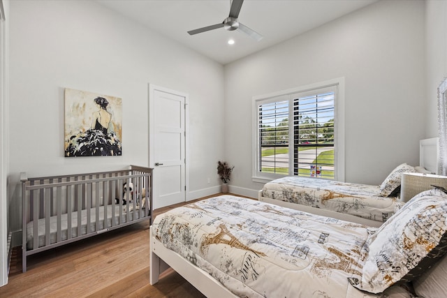 bedroom with ceiling fan and hardwood / wood-style flooring