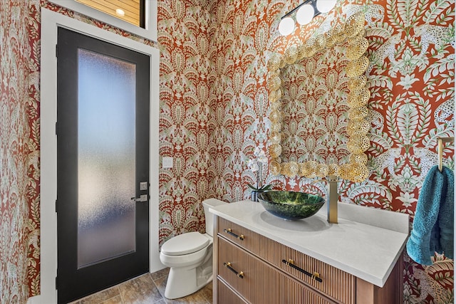 bathroom featuring tile patterned floors, toilet, and vanity